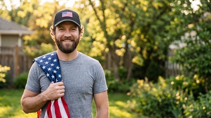 Fototapeta premium Proud patriotic American man holding US flag in backyard garden at sunset