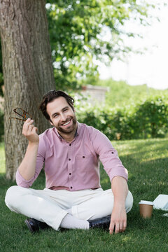 Handsome man showcasing summer style in elegant attire with an authentic smile