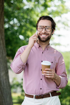 Handsome stylish man enjoying summer in elegant attire with a captivating smile