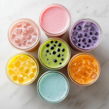 A collection of seven colorful bubble tea drinks arranged in a circle on a marble surface, a sweet treat