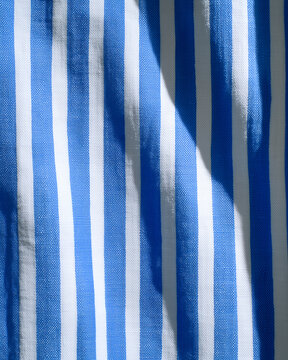 Blue and white striped fabric with light and shadow