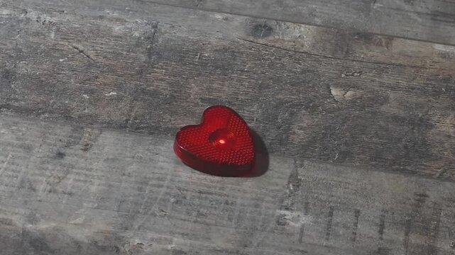 Heart shaped lantern for bicycle or outerwear on wooden surface