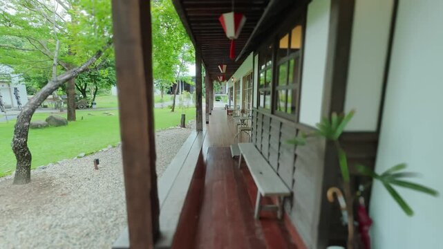 This 4K video shows a cafe with a Japanese-style veranda overlooking a Japanese garden, creating a lush and peaceful atmosphere.
