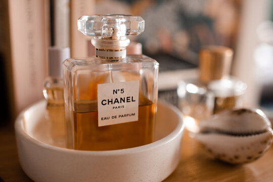 Paris, France - 23 of June 2026: fragrance glass bottle of Chanel 5 perfume on counter in tray at home close up. Aromatherapy.