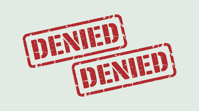 Two red rubber stamped denial messages are diagonally arranged on a pale green background denied rejected refusal rejection stamp