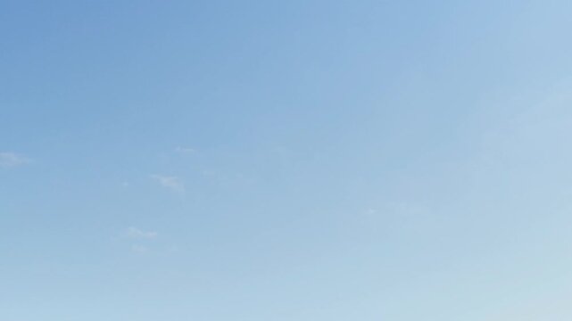 Cirrocumulus clouds moving in the blue sky early