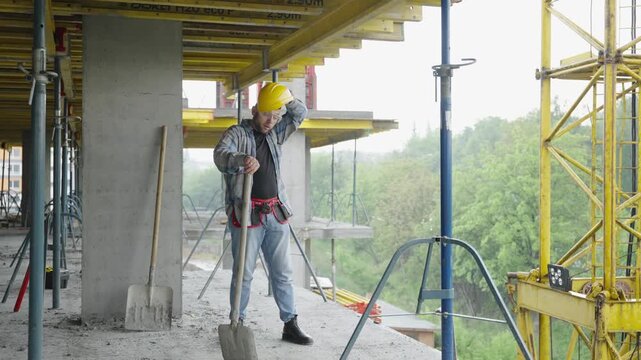 Exhausted construction worker taking a break on building site