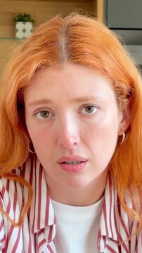 A young redhead woman displays sad and thoughtful expressions, reflecting deep emotion and melancholy. Her gaze conveys introspection, hinting at loneliness or distress, resonating with a profound sen