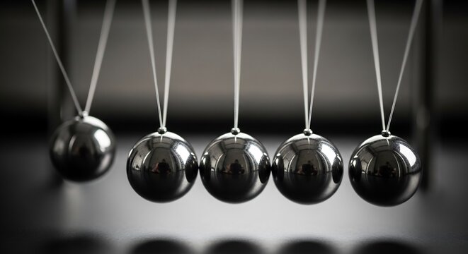 Shiny Metal Pendulum Balls Hanging in Balance on Newton Cradle