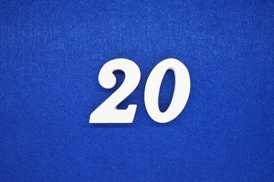 The numbers are made of wood, painted white, and placed on a blue background of paper.