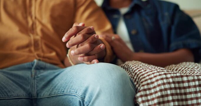 Couple, holding hands and support in lounge, home and bonding with partner on weekend or connection. People, love and commitment for relationship, loyalty and solidarity with spouse in living room