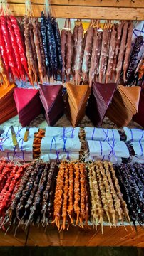Colorful variety of traditional churchkhela and tklapi sweets at a local market in Georgia