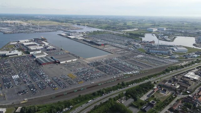Rotating drone view shows the first harbor basin encircled by cars and warehouses.