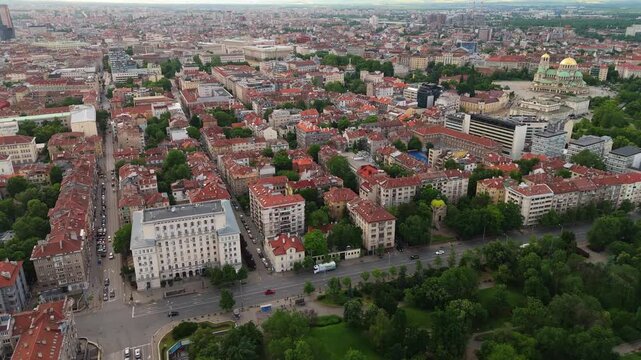 Aerial Drone Dolly In Historic Tsar Osvoboditel Boulevard with City Traffic and Landmarks in Sofia Bulgaria