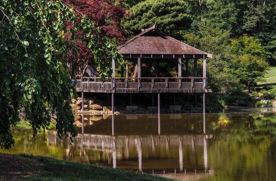A Japanese style teahouse oer a pond