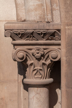 elements of architectural decorations of buildings, ancient arches and columns, pommel and patterns, on the streets in Barcelona, public places.