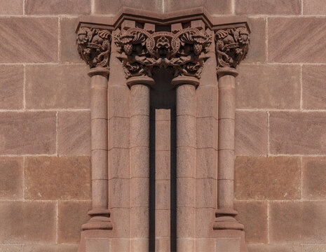 elements of architectural decorations of buildings, ancient arches and columns, pommel and patterns, on the streets in Barcelona, public places.