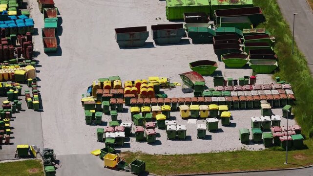Waste containers and recycling bins arranged for public sanitation services and waste collection.
