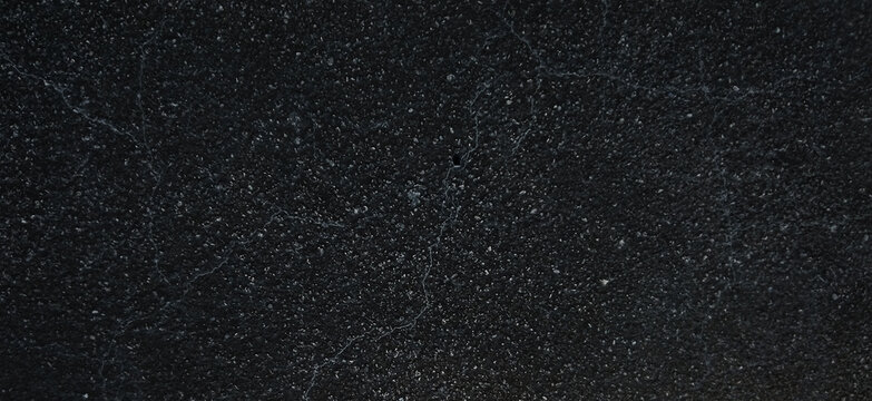 Black granite texture with white speckled mineral details, dark natural stone surface, polished charcoal marble background for luxury interior design