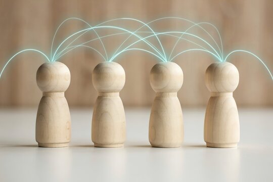Wooden peg dolls connected with glowing lines representing networking, communication, teamwork, and social connection