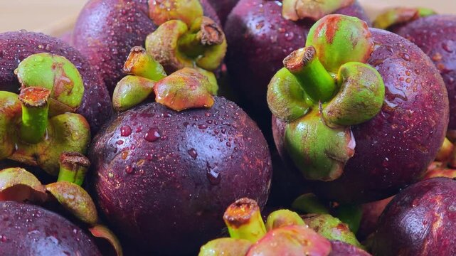 Fresh mangosteen on a wooden floor.