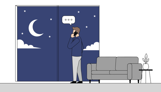 Young man making a late-night phone call while standing in front of a large window with a beautiful moon view.