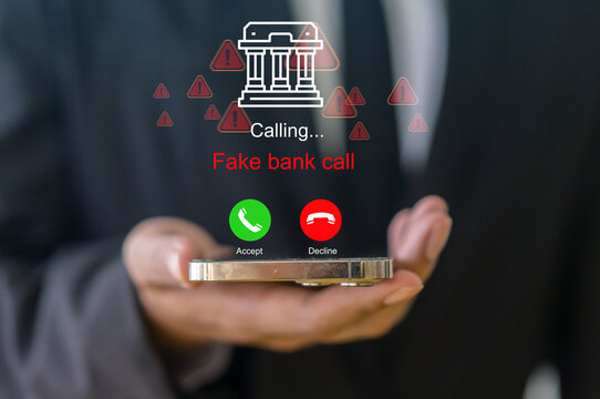 Businessman holding smartphone with fake bank call graphic interface, Financial fraud, cybercrime, scammer caller, phishing warning, online security threat, telecommunication danger and protection