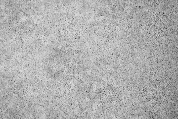 Fototapeta premium Rough gray concrete surface texture background with small dark speckles and granular details