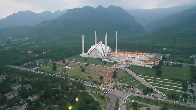 Slow Backward Drone Movement of Faisal Mosque Showing Wide Islamabad Landscape and Mountains