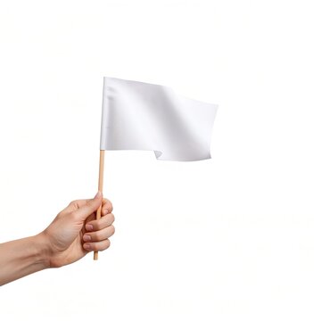 A hand holding a white flag on a wooden stick, isolated on a white background