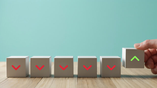 Hand Flipping Wooden Cube from Red Down Arrow to Green Up Arrow Symbolizing Business Recovery, Stock Market Growth, Financial Turnaround and Success