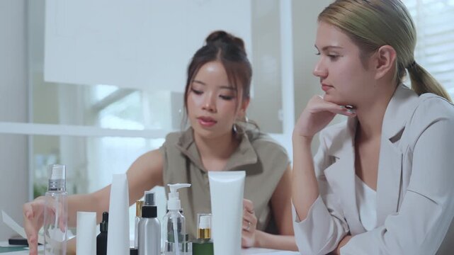 Cosmetic bottles packaging marketing research design product skincare meeting office RD review of sample container layout, bottle and pump dispenser testing, branding planning for tube launch