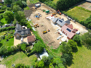 Interesting drone UAV view of a new detached bungalows being built within a small building plot in Cambridgeshire, UK. Established homes surround the site. © Nick Beer