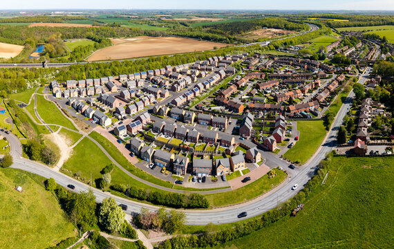 Aerial view of a new village in countryside with new build houses