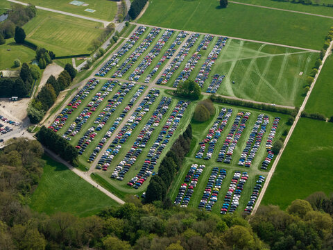 Aerial view of an overflow car park on a grass field