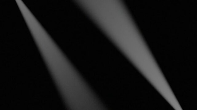 Bright white diagonal light beams dark background empty space black void illumination