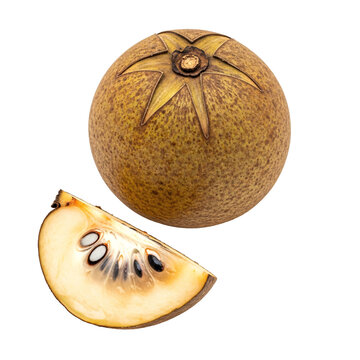 Whole and sliced sapodilla fruit showing seeds on plain surface.
