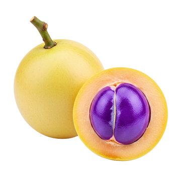 Whole yellow star apple and cut half with purple juicy pulp.
