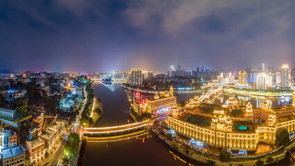 Fototapeta premium Night Cityscape with River and Illuminated Buildings