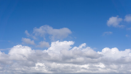 Obraz premium Clear Blue Sky With Fluffy White Clouds In Daylight