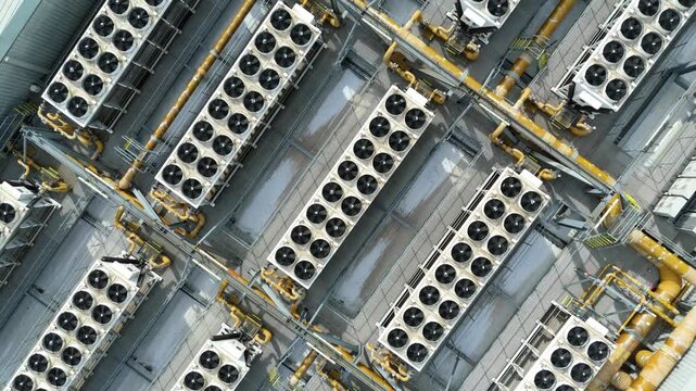Top-down aerial view of industrial power station HVAC ventilation systems in rows for mechanical cooling, Hoddesdon, UK.
