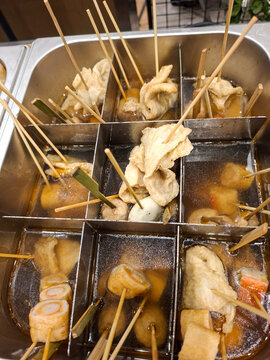 metal food warmer insert divided into compartments containing Korean fish cakes