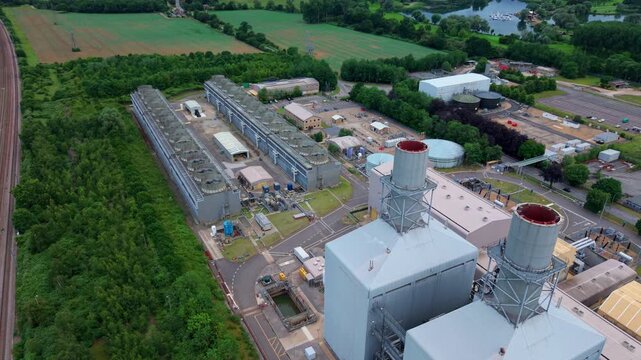 High aerial view of a gas turbine power plant showing massive industrial air cooled condenser units, England.
