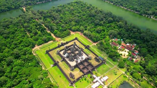Spectacular aerial drone view of Angkor Wat, the world famous UNESCO World Heritage temple complex in Siem Reap, Cambodia. Ancient Khmer architecture surrounded by lush tropical rainforest and water