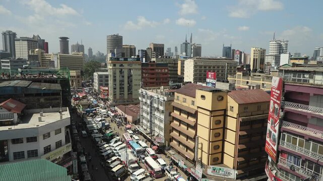 Nairobi, Kenya - 05 December 2024: View of the dense urban skyline with high-rise buildings, busy streets filled with traffic, and billboards under a clear sky in Nairobi, Kenya.
