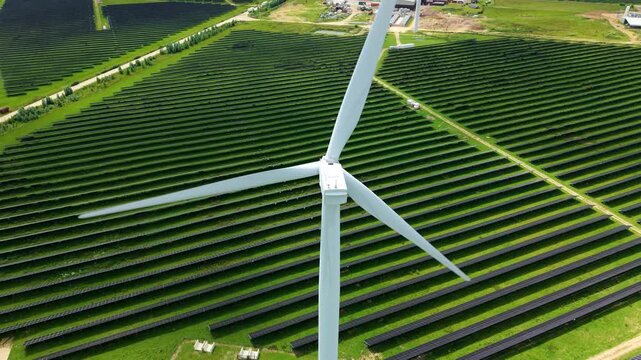 Aerial view of a massive hybrid solar and wind energy farm in rural England for net zero power resilience