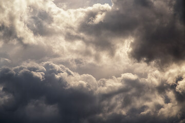 Fototapeta premium Golden Sunlight Through Dark Storm Clouds