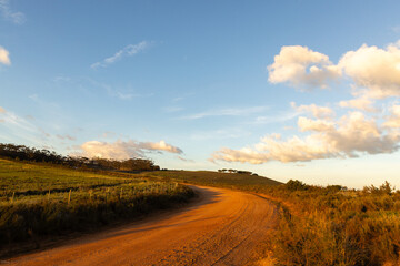 sunrise light on rural dirt road, Stanford, South Africa © Marc Romanelli