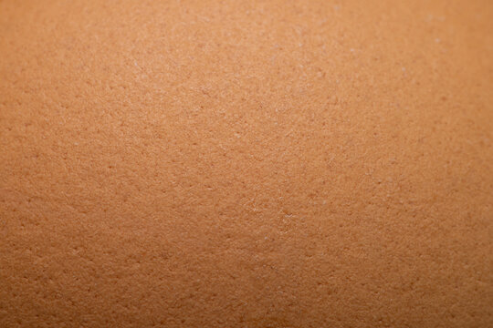 Macro Close-up Texture of a Brown Egg Shell,A detailed macro close-up shot capturing the organic texture and porous surface pattern of a brown egg shell.