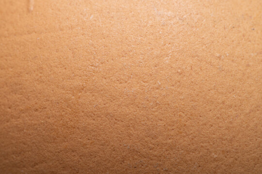 Macro Close-up Texture of a Brown Egg Shell,A detailed macro close-up shot capturing the organic texture and porous surface pattern of a brown egg shell.
